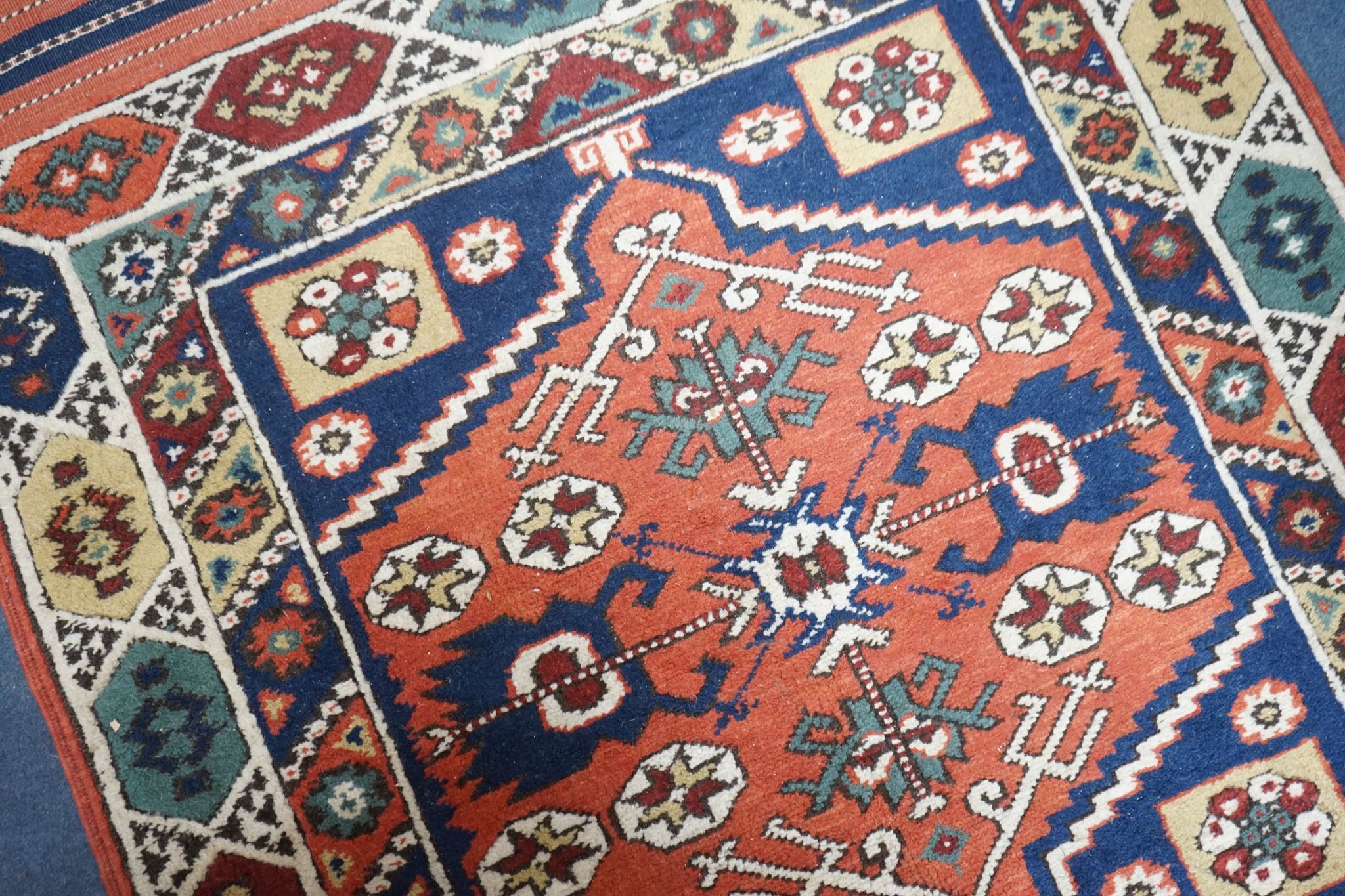 A Caucasian red ground mat, 120 x 95cm